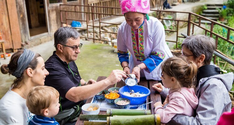 Our guests are learning to make bamboo rice with the ethnic minorities in Longsheng.