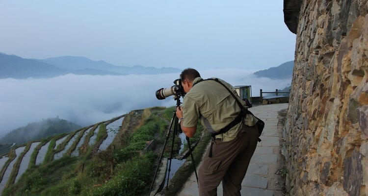 Travelers photographing Guilin scenery with China Travel guide